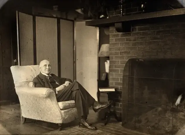 Alfred North Whitehead seated in an armchair